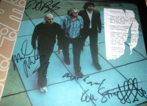 REM autograph programme signed by Michael, Mike, Peter and Ken Stringfellow. Framed with a torn piece of a lyric sheet of Everybody Hurts